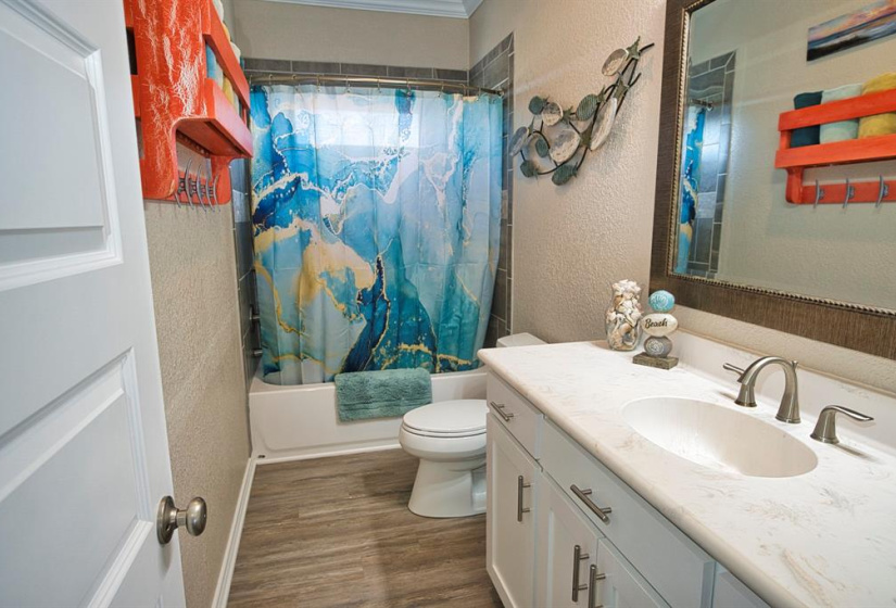 Guest Bath with Tub/Shower Combo with tile to the ceiling, Large Vanity and linen storage