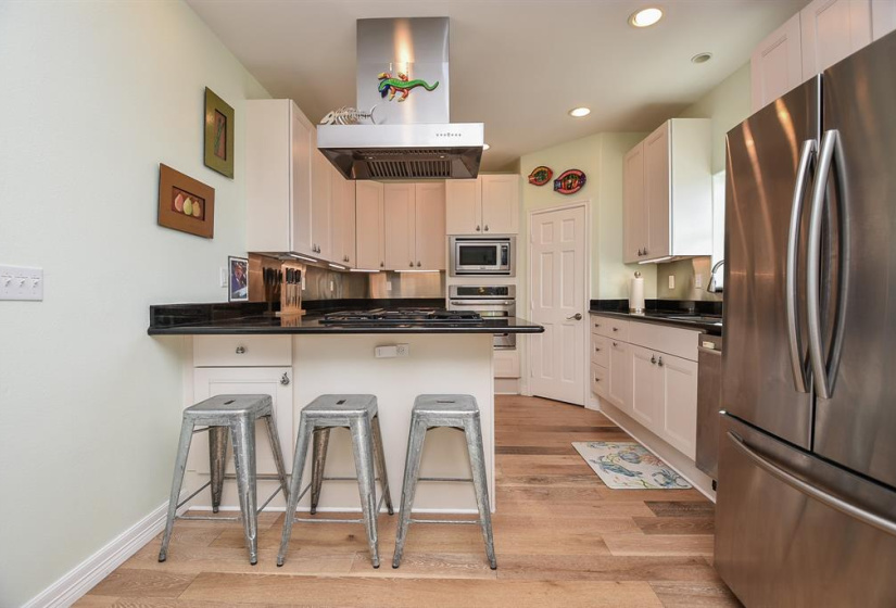 Kitchen is Open & Lighted with Breakfast Bar