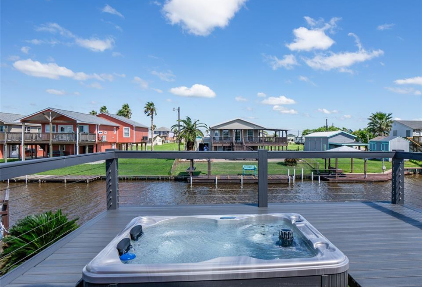 Ultimate relaxation in the hot tub on the back porch, offering serene views of the canal.