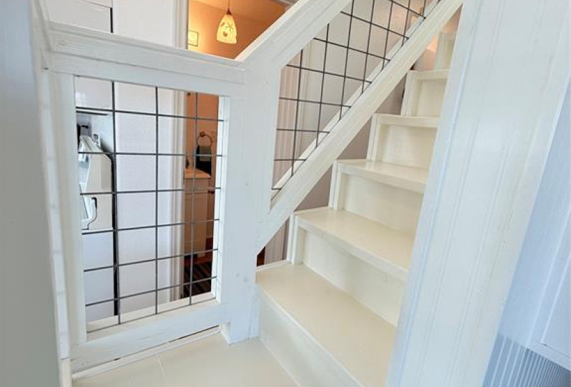 Ascend to the inviting top floor bedroom using this staircase, promising cozy and stylish living.