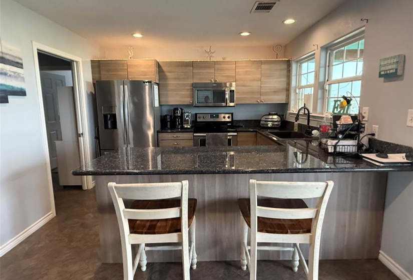 Spacious bar with seating. Perfect for cooking and entertaining.