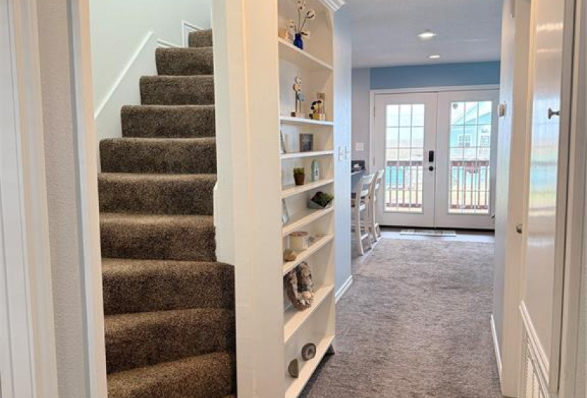 Staircase to master bedroom can be made extra private with sliding bookcase at base.