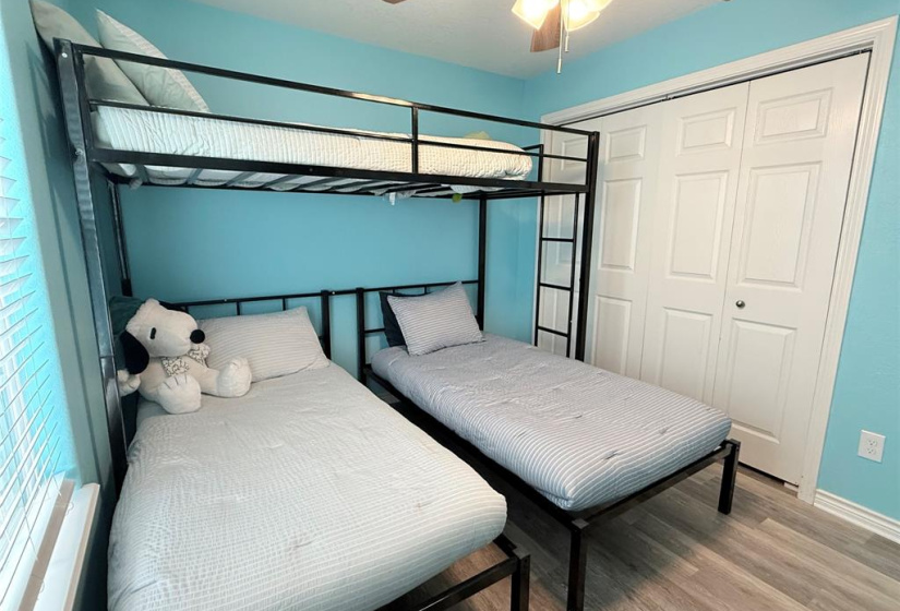 This bedroom features a twin bunk bed and an additional twin bed. great for children and guests.
