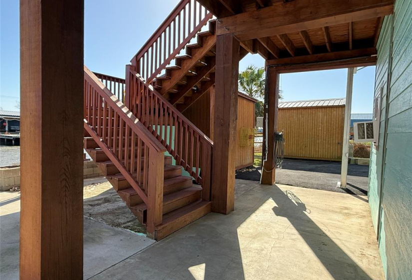 Wooden stairs on waterside leading to main floor.