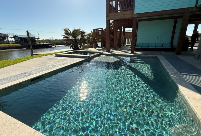 This property features a beautiful waterfront setting with a sparkling heated pool and adjacent hot tub. Plenty of outdoor area for relaxation and entertaining.