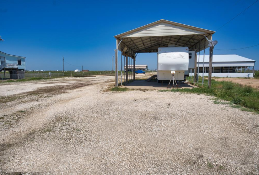 View of property from CR 201, smaller of the 2 RVs - the large RV and cover is in the background to the right