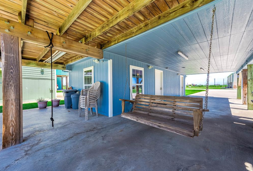 Swing under home with view of creek.