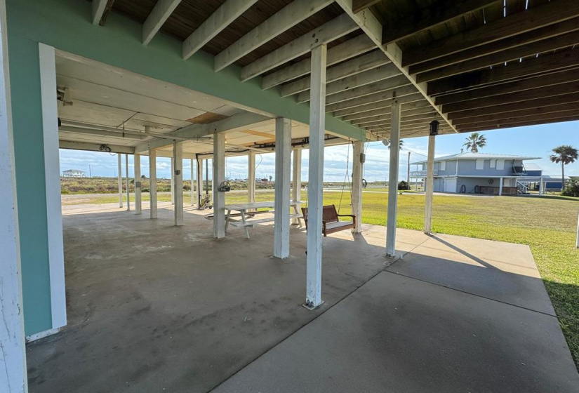 Covered area with swing and picnic table.