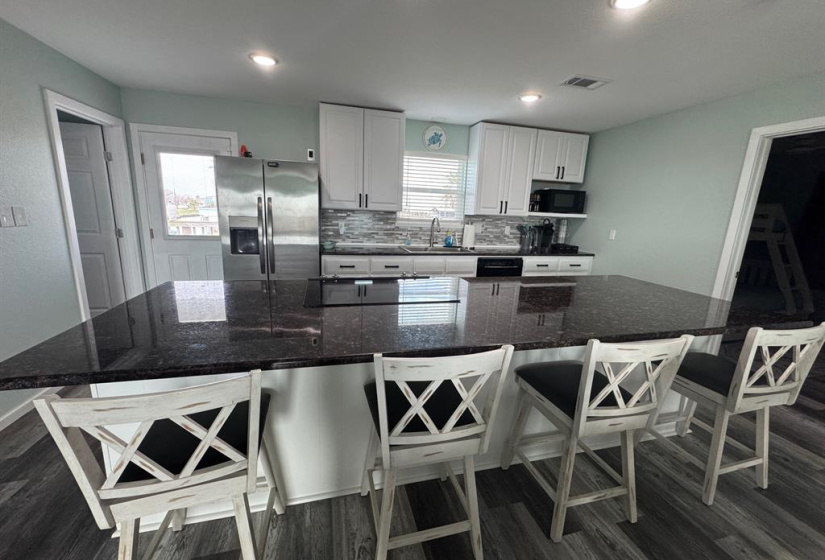 Spacious kitchen, dining and living rooms.