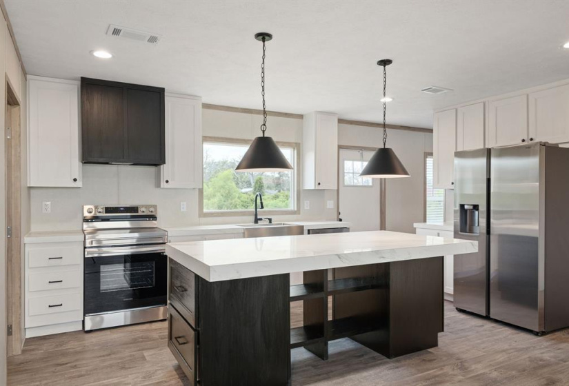 The ISLAND KITCHEN offers great cabinet and countertop space. There is additional storage on both ends of the island