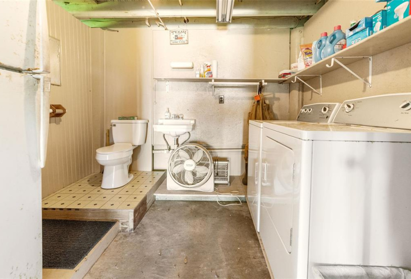 Half bath/laundry room downstairs in screened in porch.