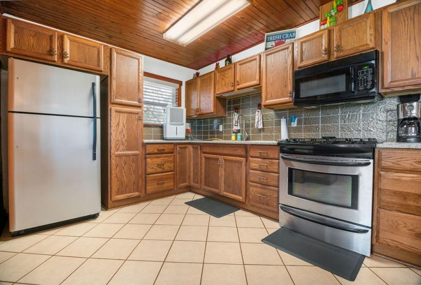 This kitchen boasts a GAS stove, built-in microwave, soft close cabinets and plenty of room for all the cooks in the house.