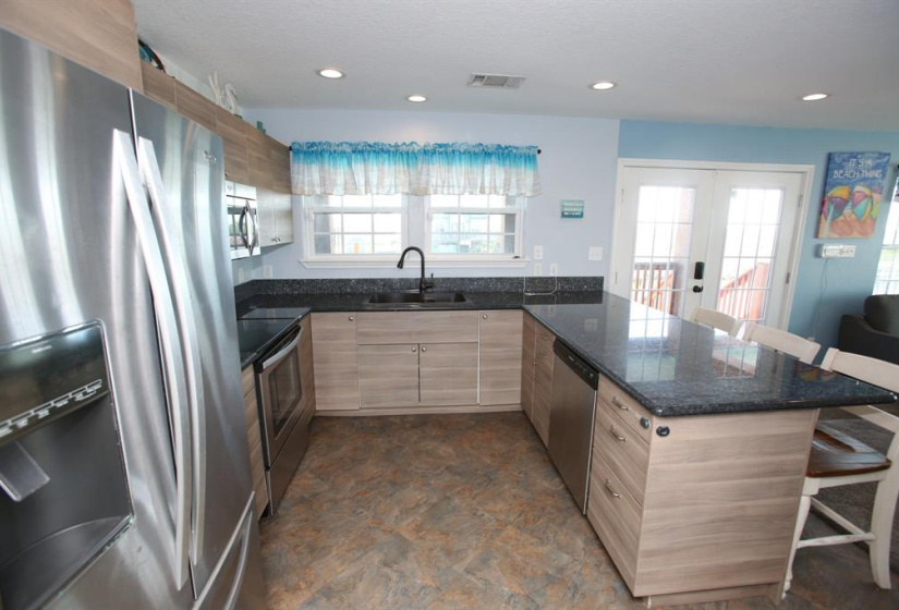 Granite countertop, soft close cabinets and 3 door refrigerator.