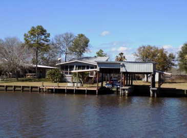 This 2/1 on TWO Caney Creek lots with double boatlift, pier, sundeck and screened porch, open floor plan with a beautiful rock fireplace!  Must see!