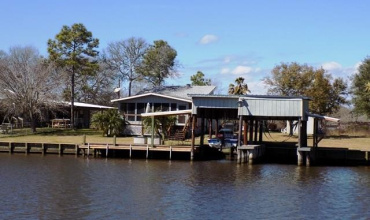 This 2/1 on TWO Caney Creek lots with double boatlift, pier, sundeck and screened porch, open floor plan with a beautiful rock fireplace!  Must see!