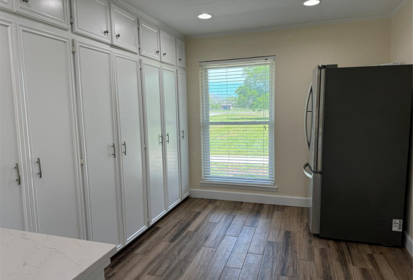 Look at this gigantic butler's pantry with SO MUCH STORAGE! The full size refrigerator looks small in this room! So many potential uses for this room! What could you use it for?