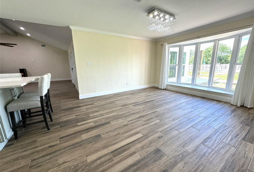 Large dining area with a great bay window looking out at the pool and Caney Creek connects with your chef's kitchen for serving your family and friends. The table in the pic seats 8 and there is still plenty of room for an even larger table if you desire!