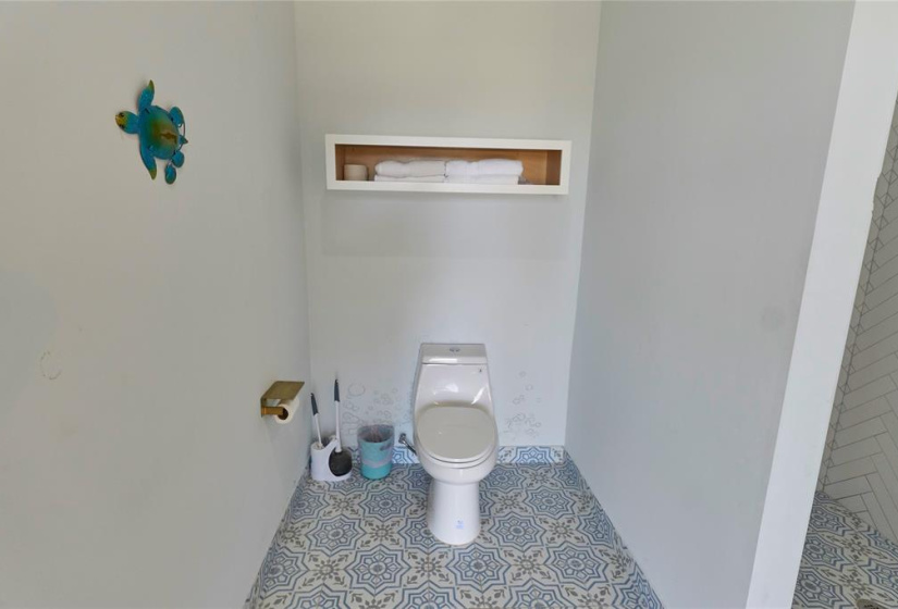 The third bathroom has beautiful custom tile.