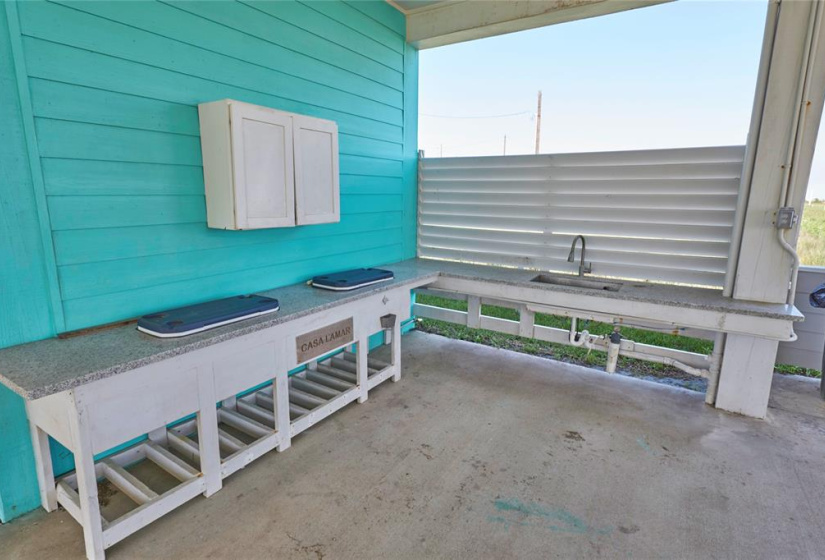 The covered patio has an outdoor sink and prep area!